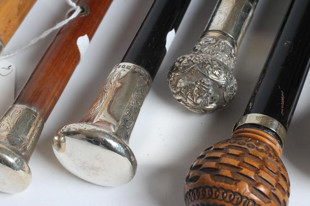 AN EBONISED WALKING CANE with carved wood ball grip Image