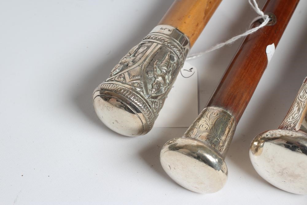 AN EBONISED WALKING CANE with carved wood ball grip Image