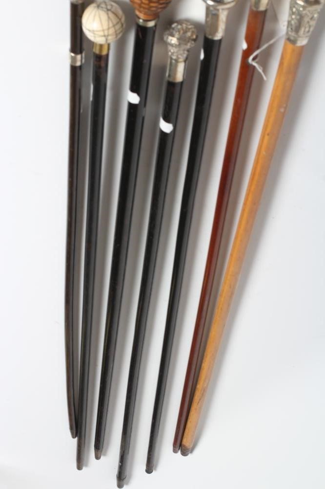 AN EBONISED WALKING CANE with carved wood ball grip Image