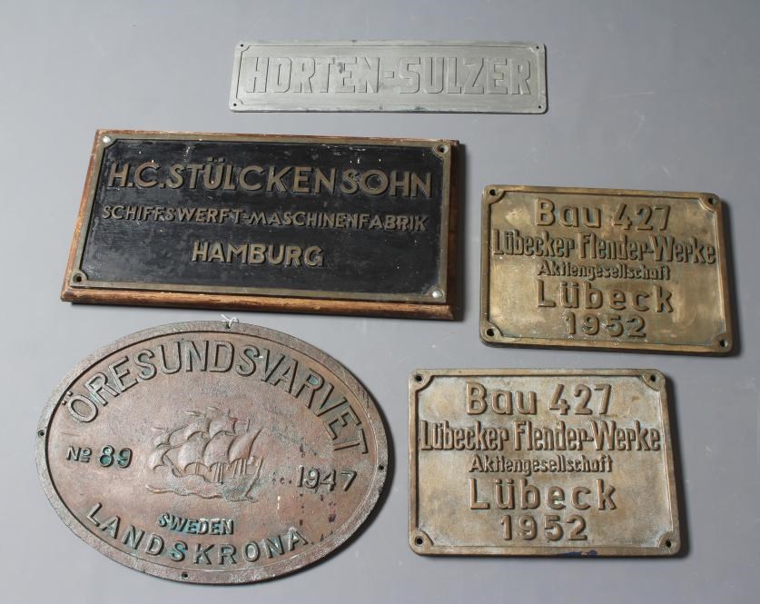 A COLLECTION OF BRONZE SHIP BUILDERS' NAME PLATES including a pair from the Lubecker Flander-Werke Image