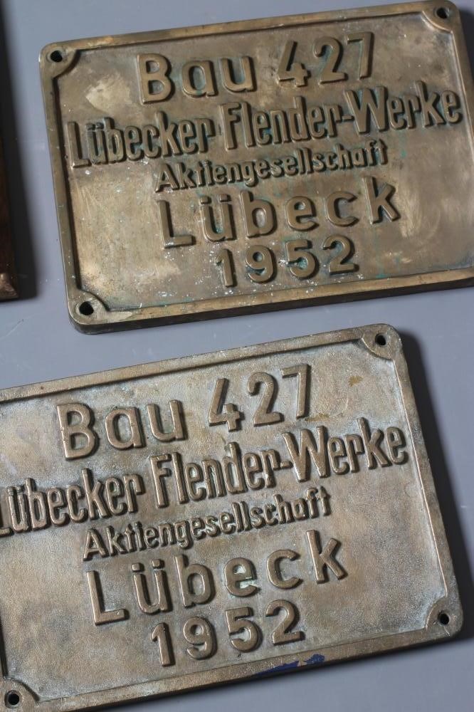A COLLECTION OF BRONZE SHIP BUILDERS' NAME PLATES including a pair from the Lubecker Flander-Werke Image