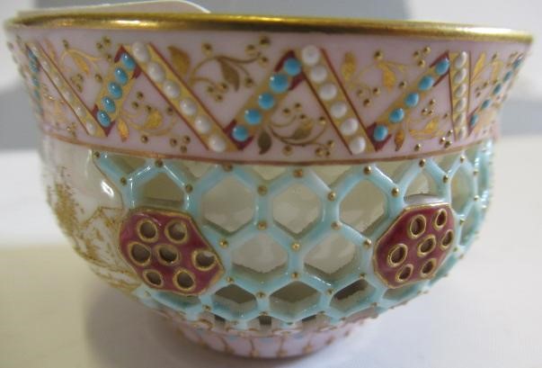 A LATE VICTORIAN ROYAL WORCESTER CHINA RETICULATED CABINET CUP AND SAUCER Image