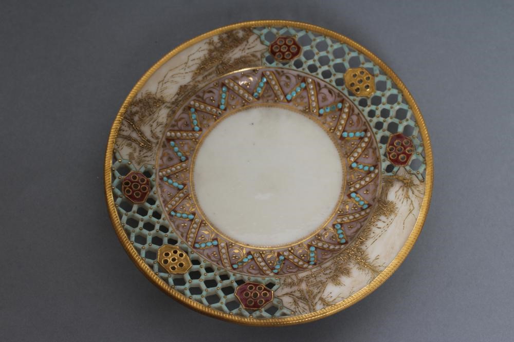 A LATE VICTORIAN ROYAL WORCESTER CHINA RETICULATED CABINET CUP AND SAUCER Image