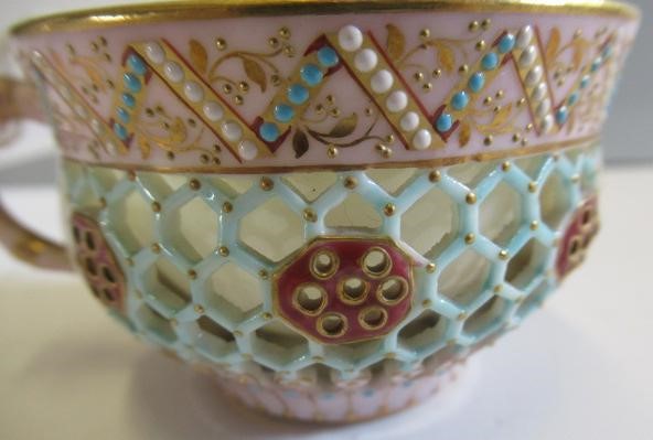 A LATE VICTORIAN ROYAL WORCESTER CHINA RETICULATED CABINET CUP AND SAUCER Image
