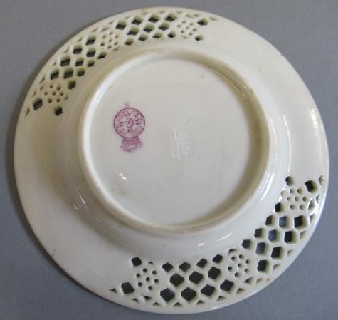 A LATE VICTORIAN ROYAL WORCESTER CHINA RETICULATED CABINET CUP AND SAUCER Image