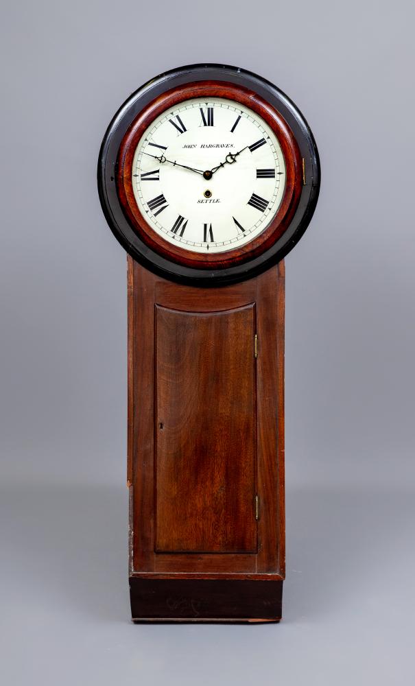 A MAHOGANY AND EBONISED CARVED TAVERN CLOCK by John Hargreaves Image
