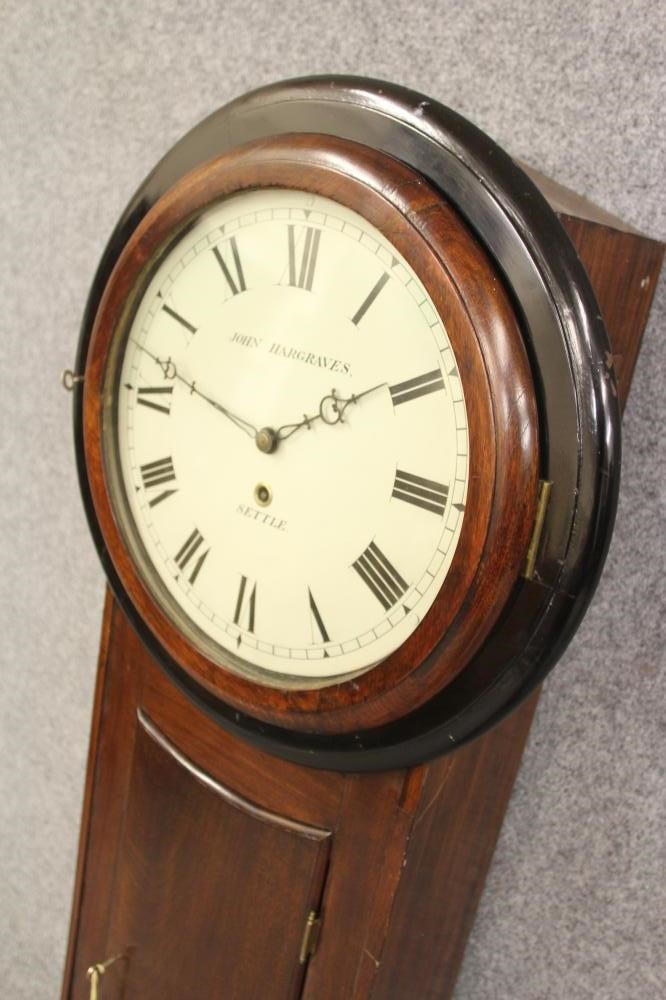 A MAHOGANY AND EBONISED CARVED TAVERN CLOCK by John Hargreaves Image
