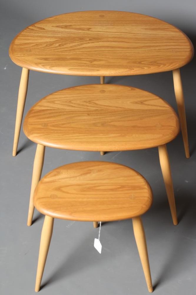 AN ERCOL BEECH AND ELM NEST OF THREE "PEBBLE" TABLES Image