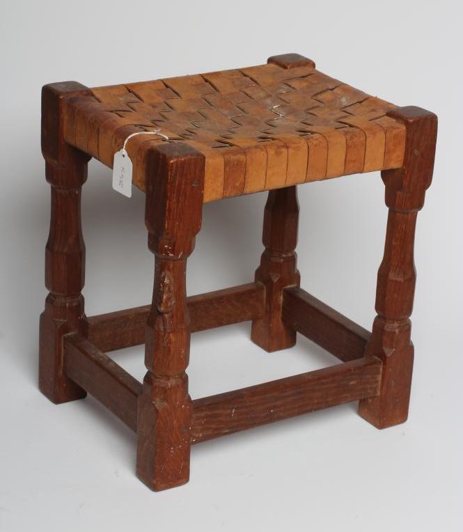 A ROBERT THOMPSON OAK STOOL of oblong form with lattice leather seat Image