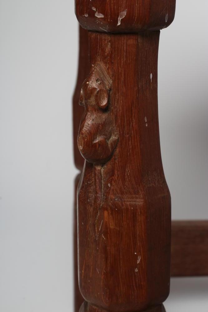 A ROBERT THOMPSON OAK STOOL of oblong form with lattice leather seat Image