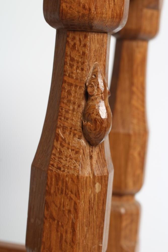 A ROBERT THOMPSON ADZED OAK STOOL of dished oblong form with faceted baluster turned and block legs Image