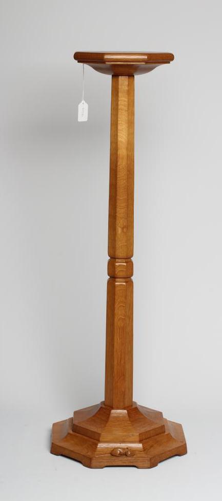 A ROBERT THOMPSON OAK PLANT STAND of octagonal form with collared tapering stem Image