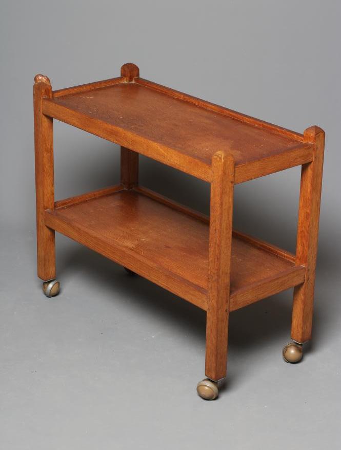 A ROBERT THOMPSON ADZED OAK TEA TROLLEY of oblong two tier form Image