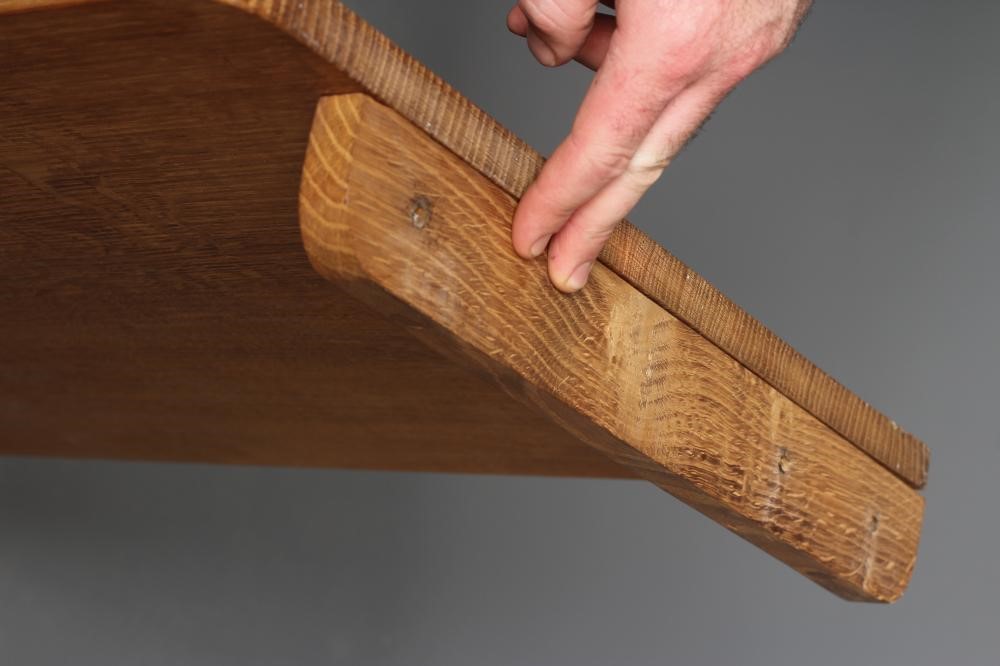 A ROBERT THOMPSON OAK WALL SHELF of rounded oblong form with carved mouse trademark in high relief Image