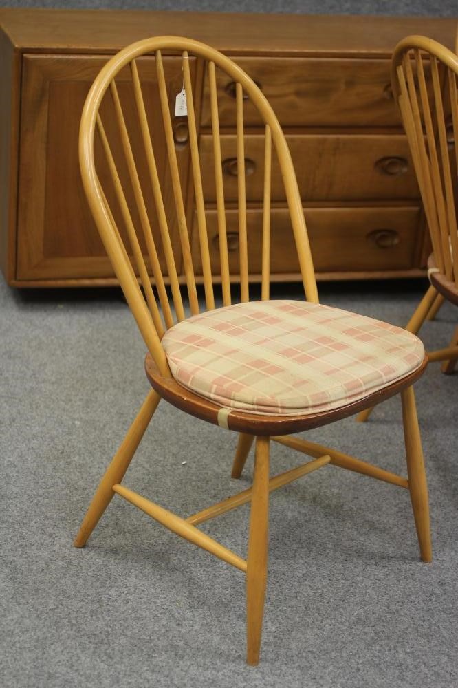 AN ERCOL WINDSOR BEECH AND ELM DINING SUITE comprising an extending table with rounded oblong top Image
