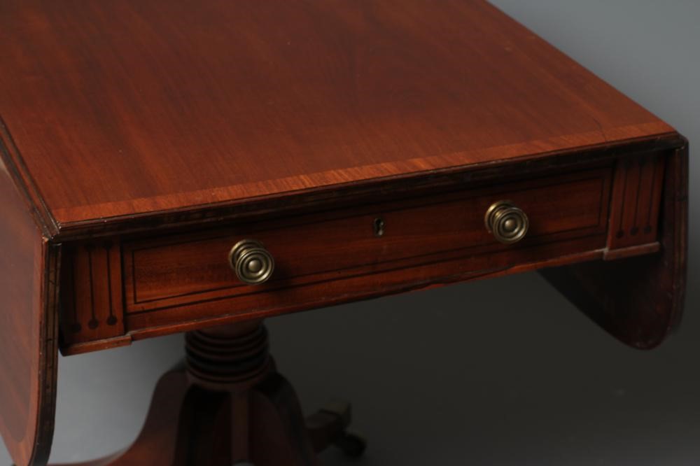 A REGENCY MAHOGANY PEMBROKE TABLE of rounded oblong form with stringing Image