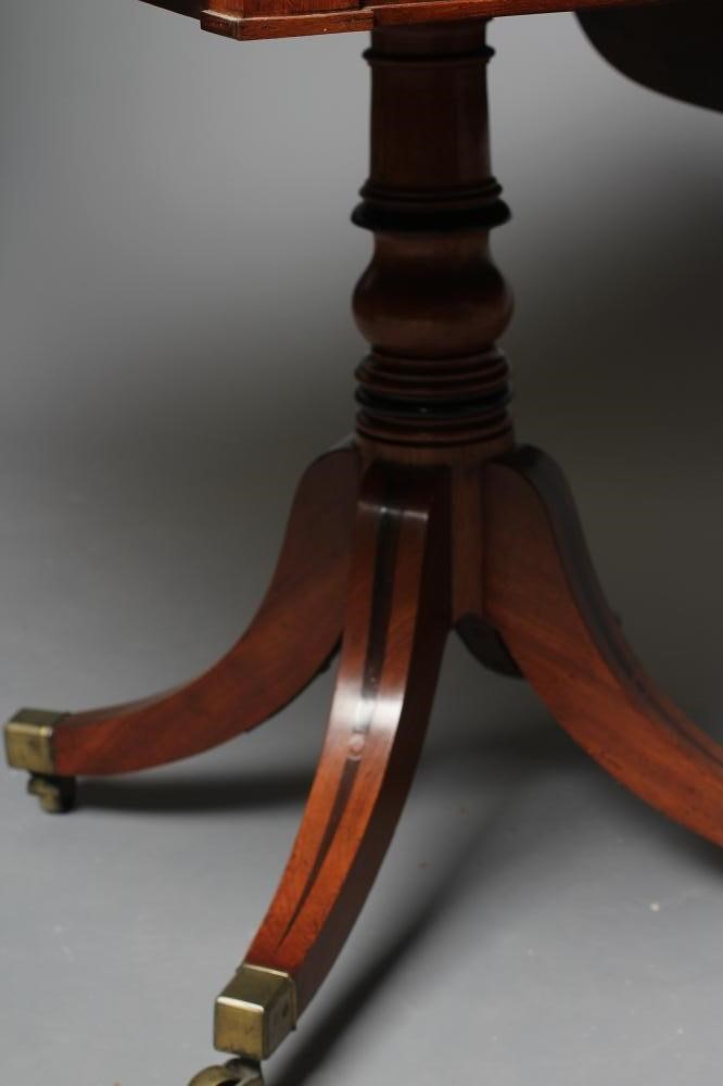 A REGENCY MAHOGANY PEMBROKE TABLE of rounded oblong form with stringing Image