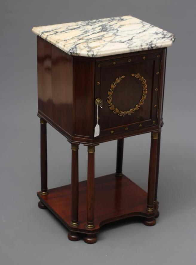 A FRENCH EMPIRE STYLE MAHOGANY BEDSIDE COMMODE of canted oblong form with gilt metal mounts Image