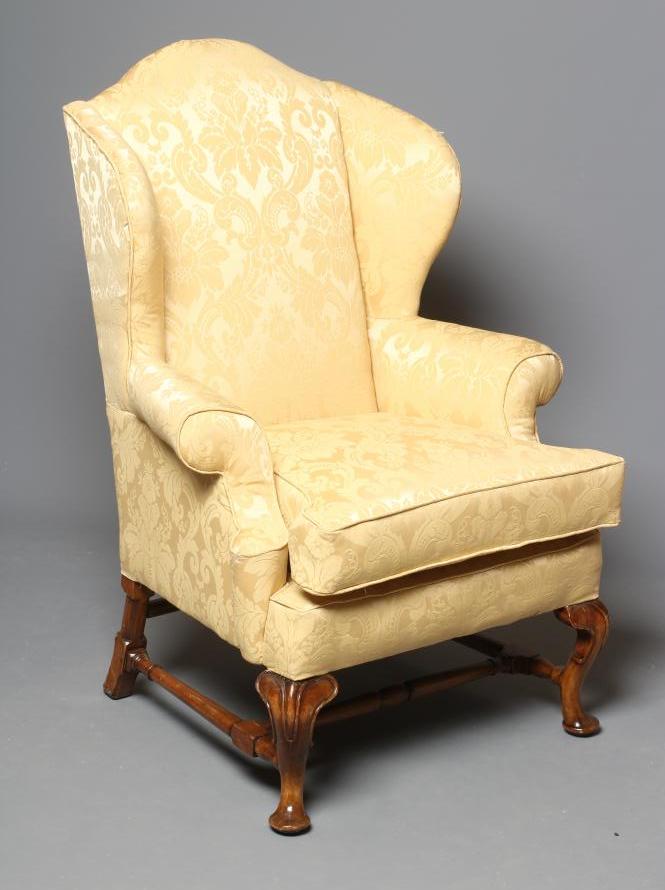 A WALNUT FRAMED WING ARMCHAIR Image