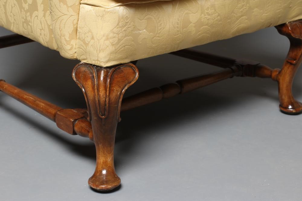 A WALNUT FRAMED WING ARMCHAIR Image