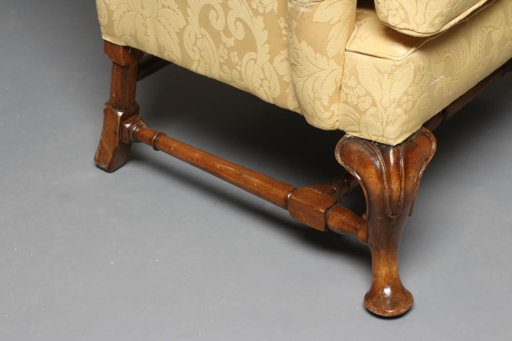 A WALNUT FRAMED WING ARMCHAIR Image