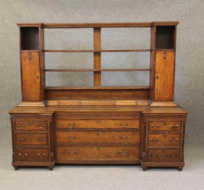 A GEORGIAN OAK AND MAHOGANY BANDED LARGE DRESSER of inverted breakfront form Image
