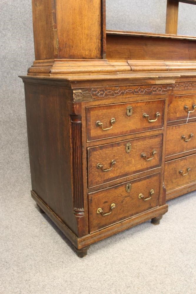 A GEORGIAN OAK AND MAHOGANY BANDED LARGE DRESSER of inverted breakfront form Image