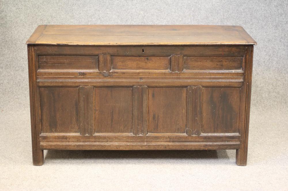 AN OAK PANELLED COFFER Image