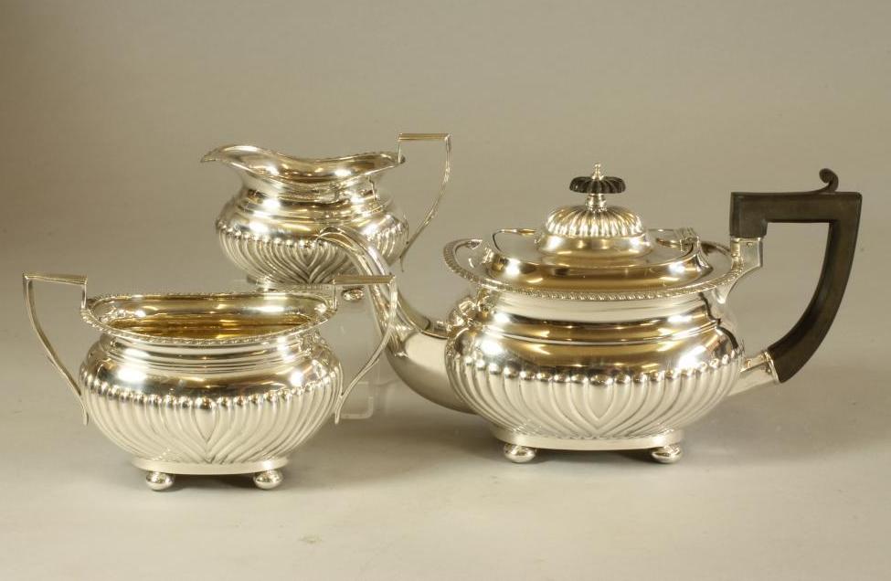 A MATCHED THREE PIECE SILVER TEA SERVICE Image