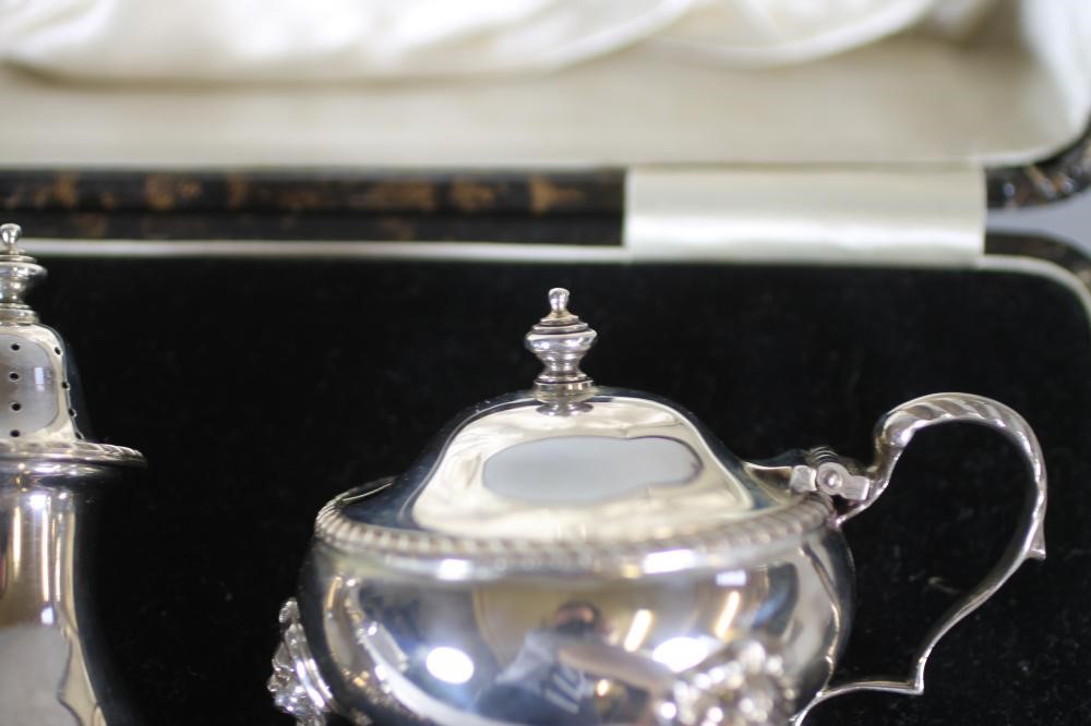 A THREE PIECE SILVER CRUET Image