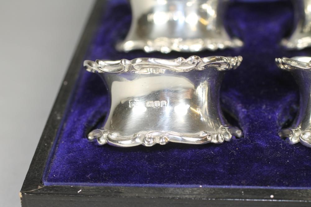 A SET OF SIX EDWARDIAN SILVER NAPKIN RINGS Image
