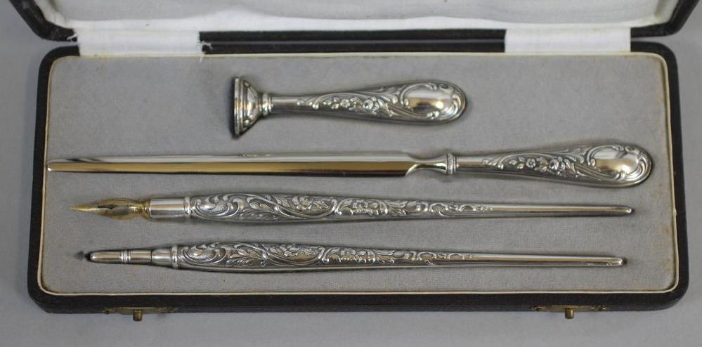 A FOUR PIECE SILVERED DESK SET Image