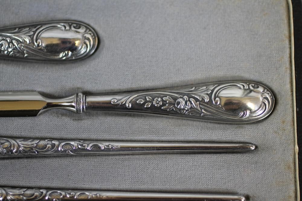 A FOUR PIECE SILVERED DESK SET Image