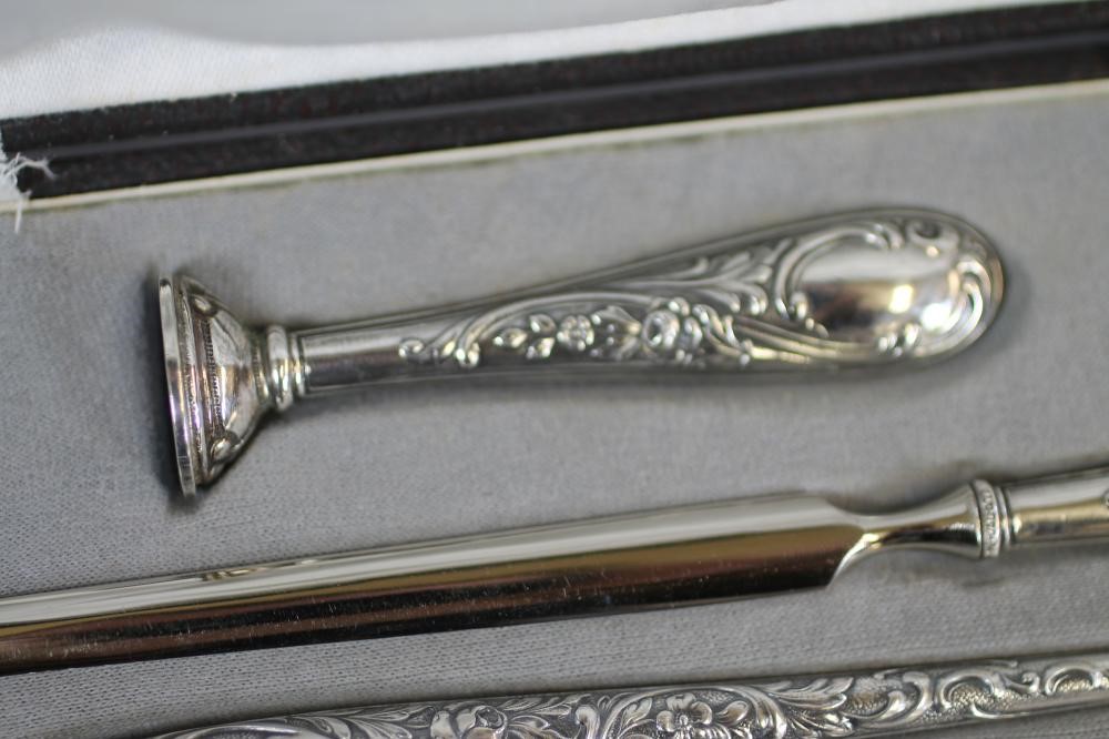 A FOUR PIECE SILVERED DESK SET Image