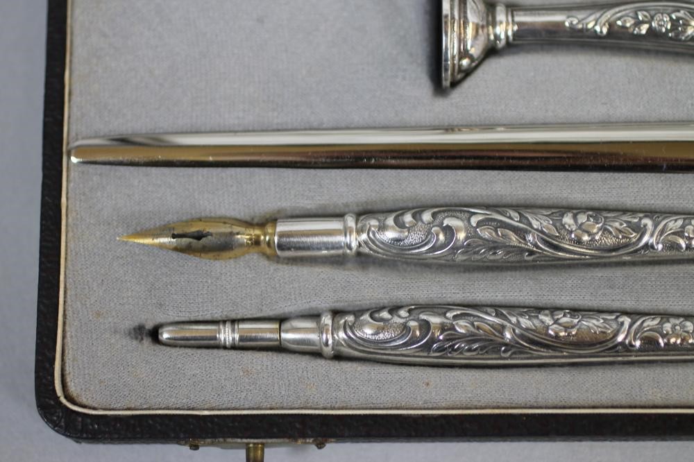 A FOUR PIECE SILVERED DESK SET Image