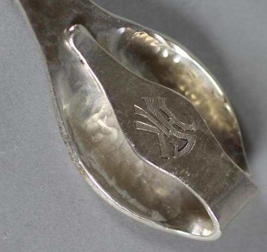 A PAIR OF LATE VICTORIAN SILVER AND IVORY KNIFE RESTS Image