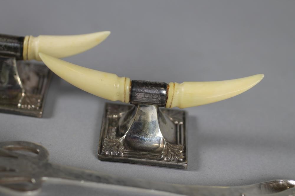 A PAIR OF LATE VICTORIAN SILVER AND IVORY KNIFE RESTS Image