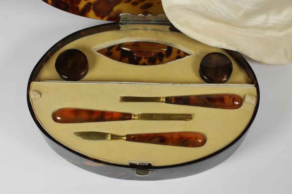 AN ART DECO TORTOISESHELL CASED MANICURE SET of plain oval form Image