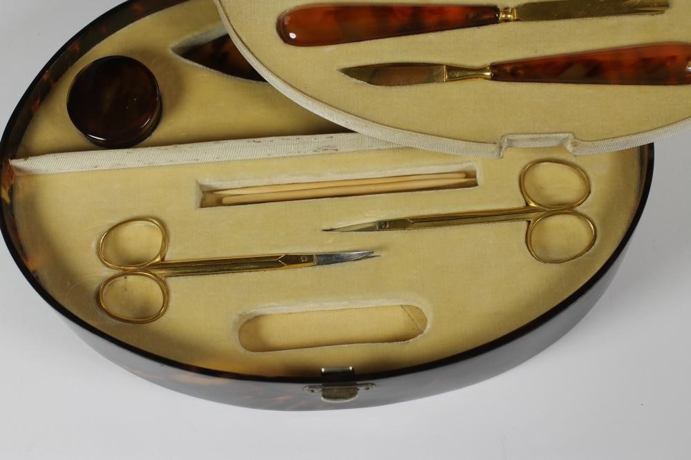 AN ART DECO TORTOISESHELL CASED MANICURE SET of plain oval form Image