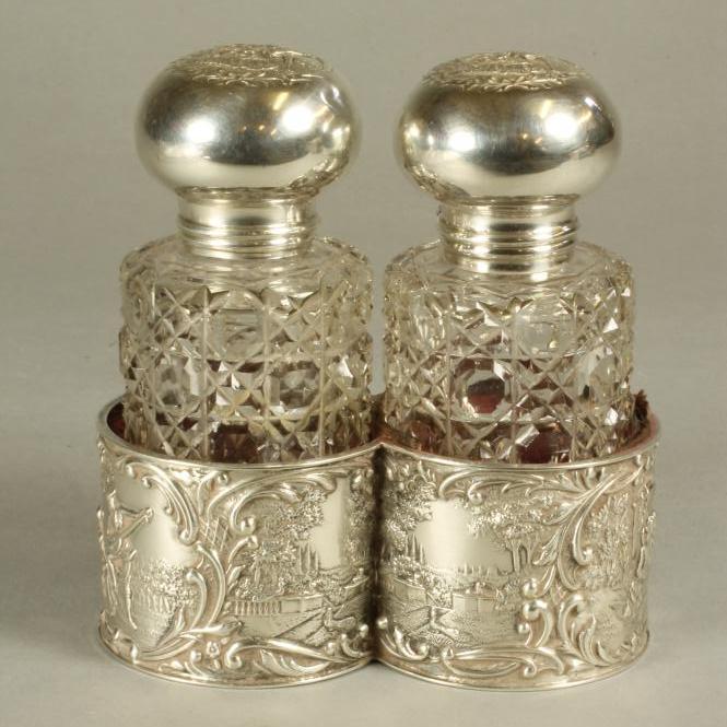 A PAIR OF LATE VICTORIAN GLASS TOILET BOTTLES of plain cylindrical form with hobnail cutting Image