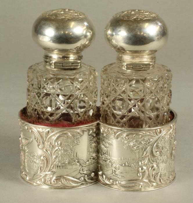 A PAIR OF LATE VICTORIAN GLASS TOILET BOTTLES of plain cylindrical form with hobnail cutting Image