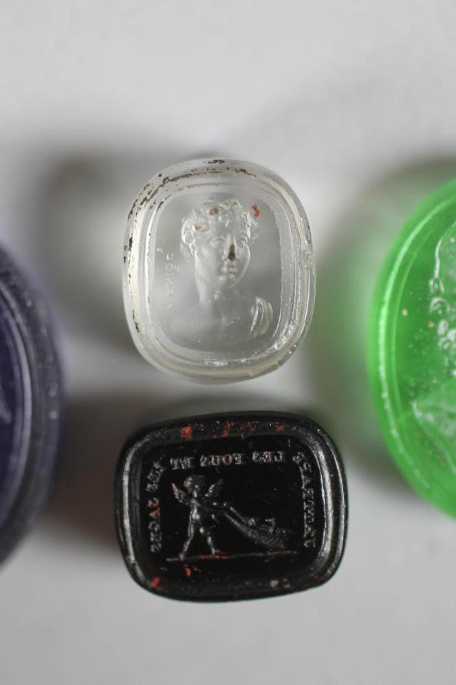 A COLLECTION OF FOUR TASSIE TYPE SEALS comprising an oval transparent green seal depicting a Image