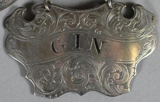 A PAIR OF VICTORIAN SILVER DECANTER LABELS Image