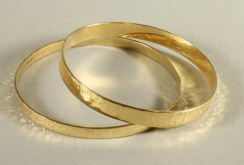 A PAIR OF 9CT GOLD PLANISHED BANGLES of plain form Image