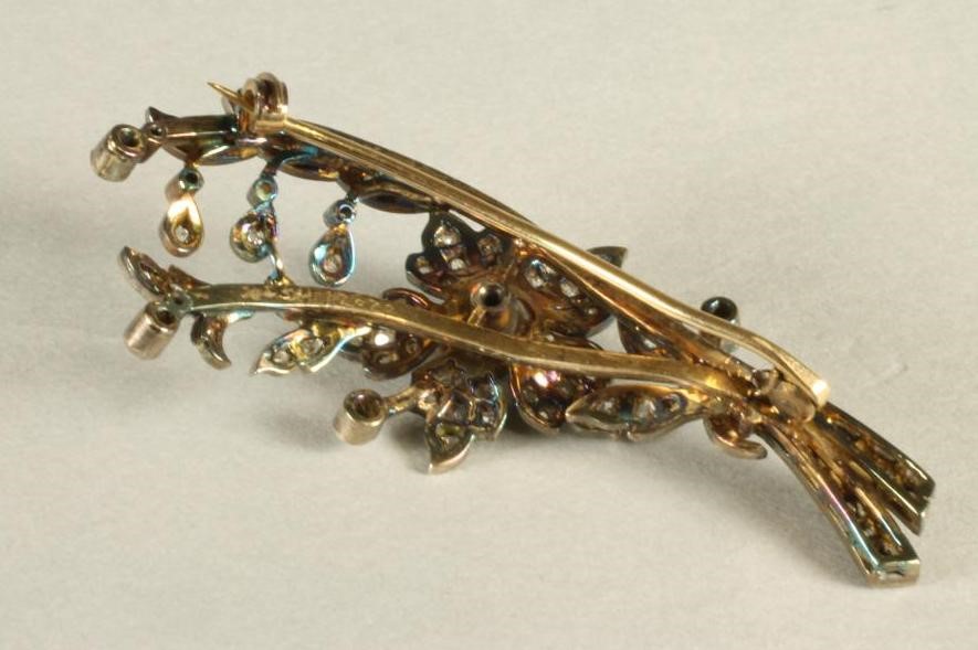 A LATE VICTORIAN DIAMOND FLOWER SPRAY BROOCH with central flowerhead issuing from a ribbon tied Image