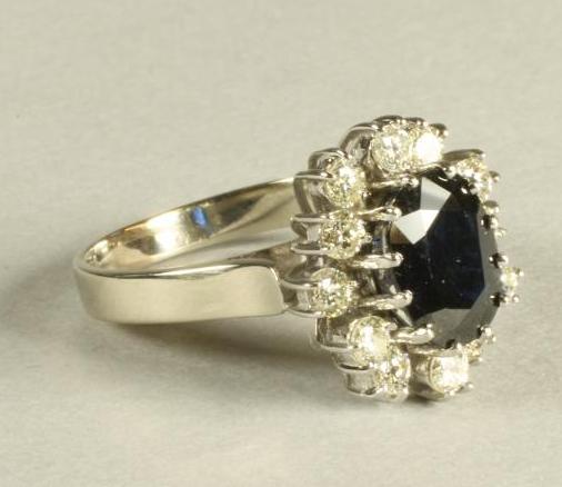 A SAPPHIRE AND DIAMOND CLUSTER RING Image