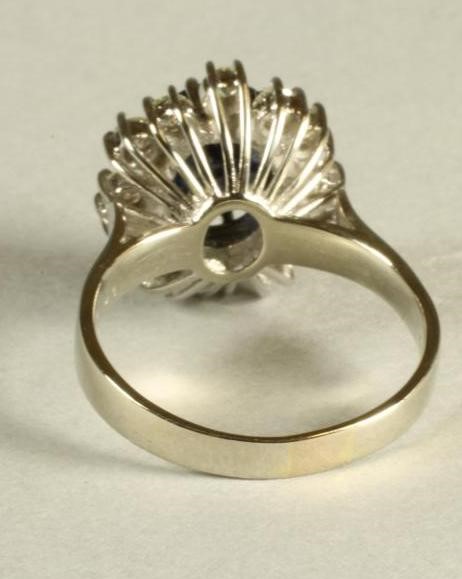 A SAPPHIRE AND DIAMOND CLUSTER RING Image