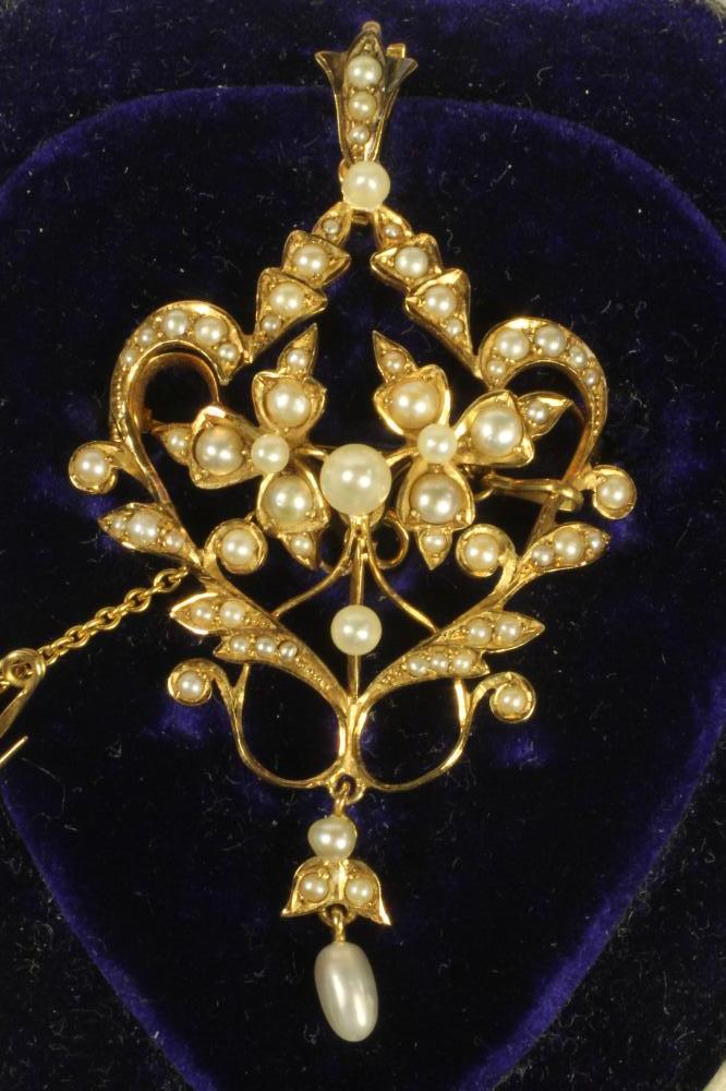 A LATE VICTORIAN 15CT GOLD PENDANT/BROOCH of open cartouche form set with numerous seed pearls and Image