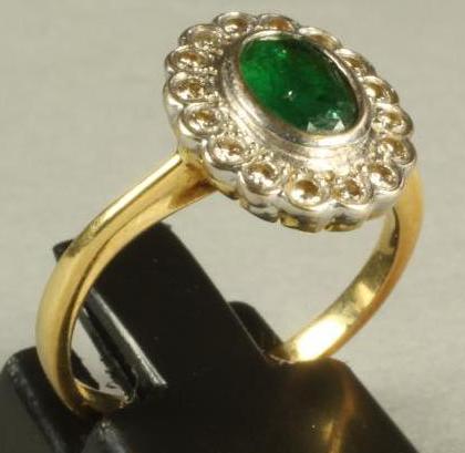 AN EMERALD AND DIAMOND CLUSTER RING Image