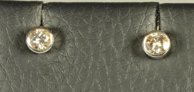 A PAIR OF DIAMOND STUD EARRINGS Image